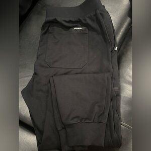 3 pair of Jaanuu black jogger scrub pants. Size medium, petite.